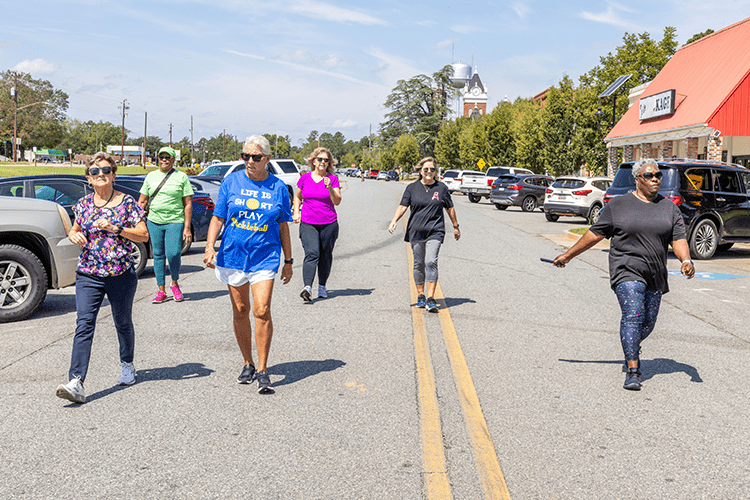 participants in the walk-a-thon walking through a paved roadway