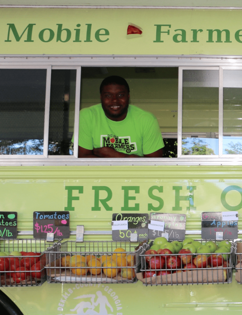 a smiling Extension employee inside the Fresh on Dek truck