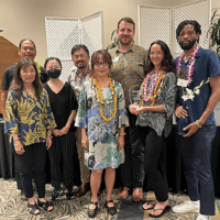 a group of smiling University of Hawaii faculty and staff