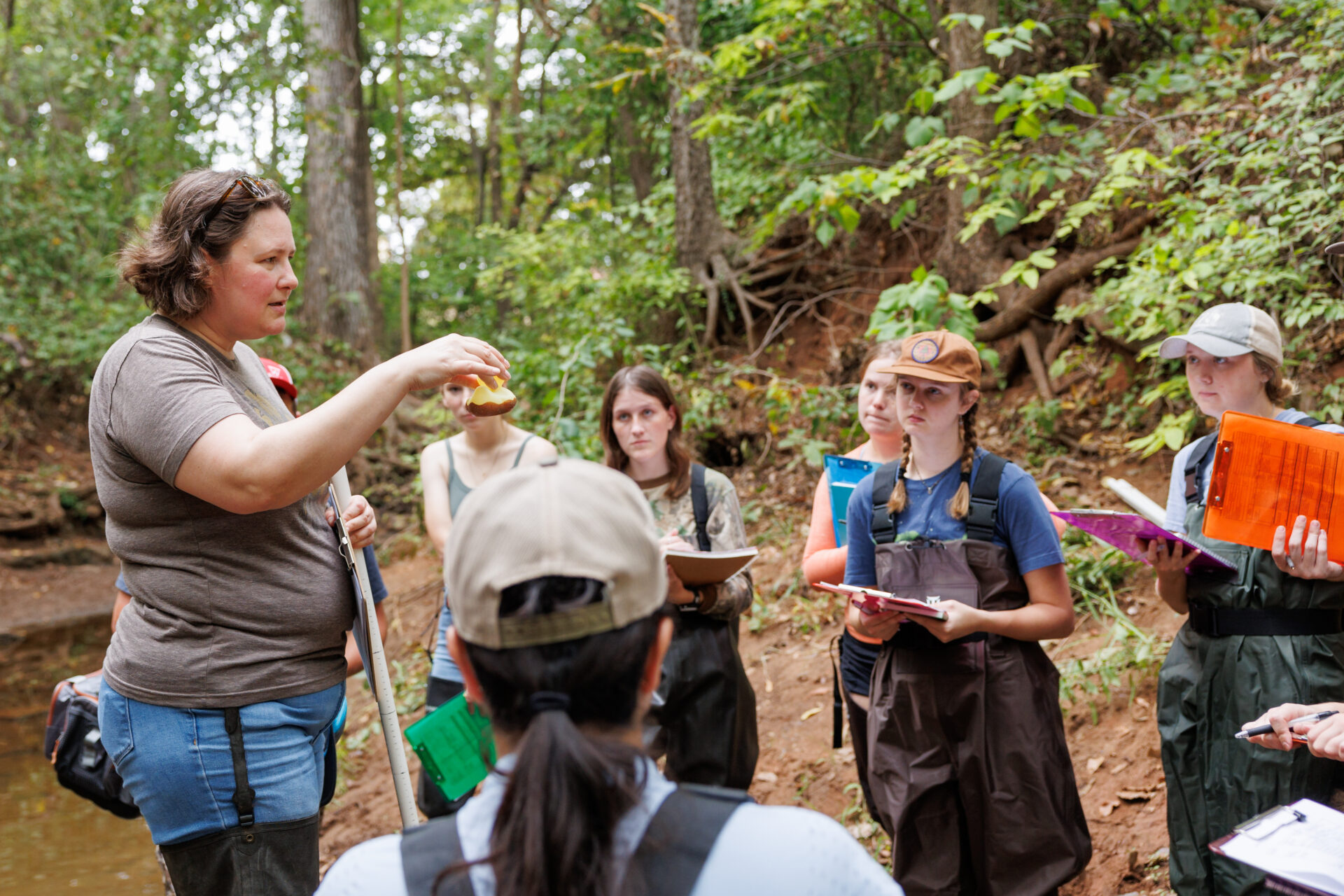 a professor teaches students in the field