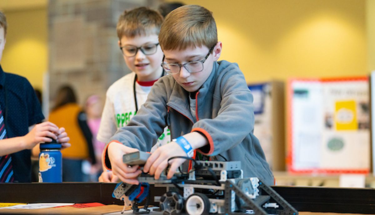 a 4-H student operates a robot