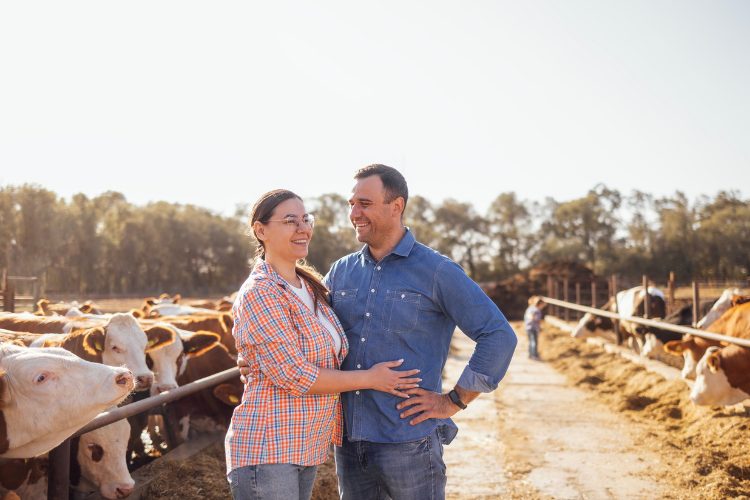 a farming couple smiling