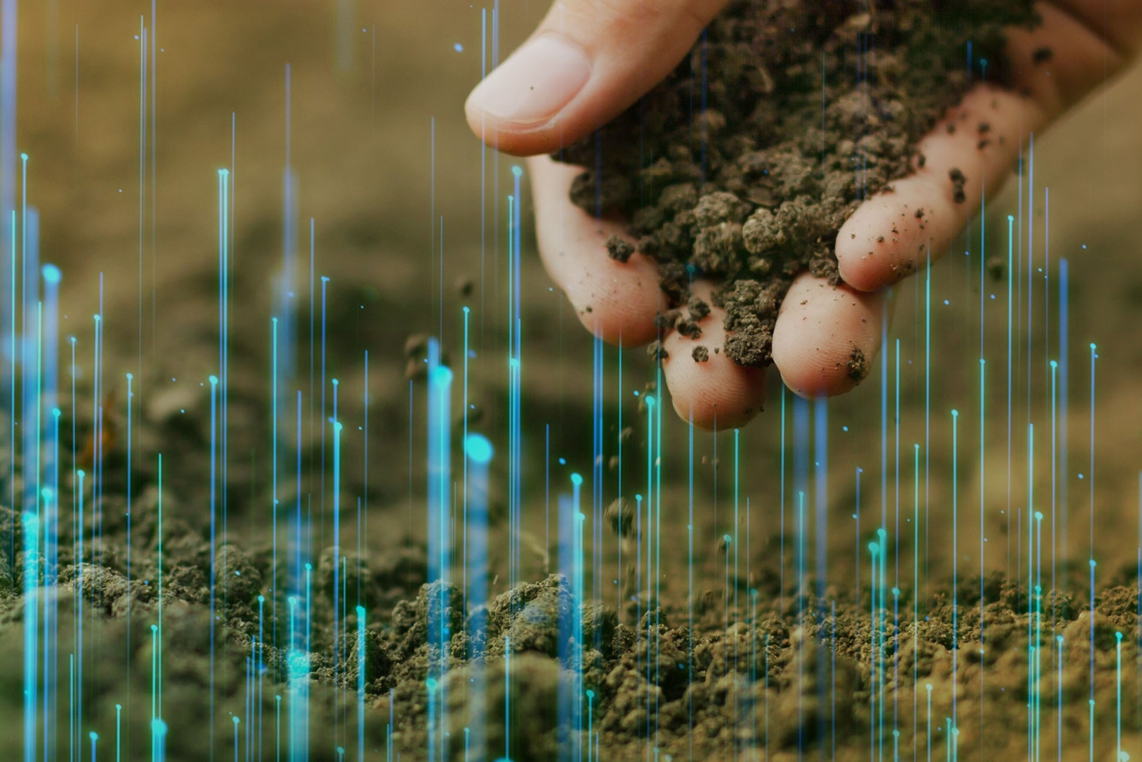a hand picking up soil, editing technological symbolism